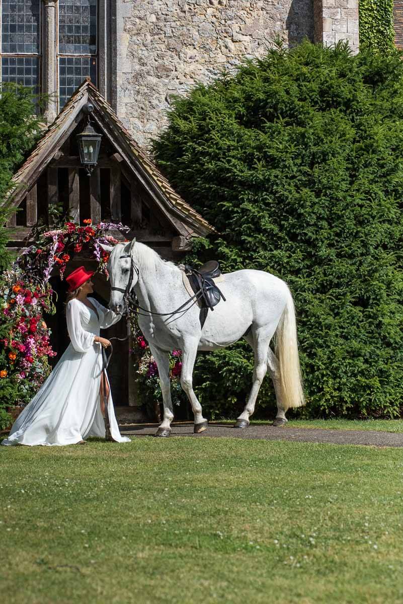 A bride with her horse outside the Priory at Bilsington