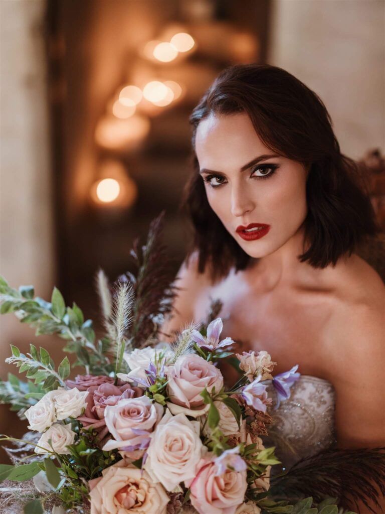 A bride and bouquet in the Great Hall of Bilsington Priory Allington